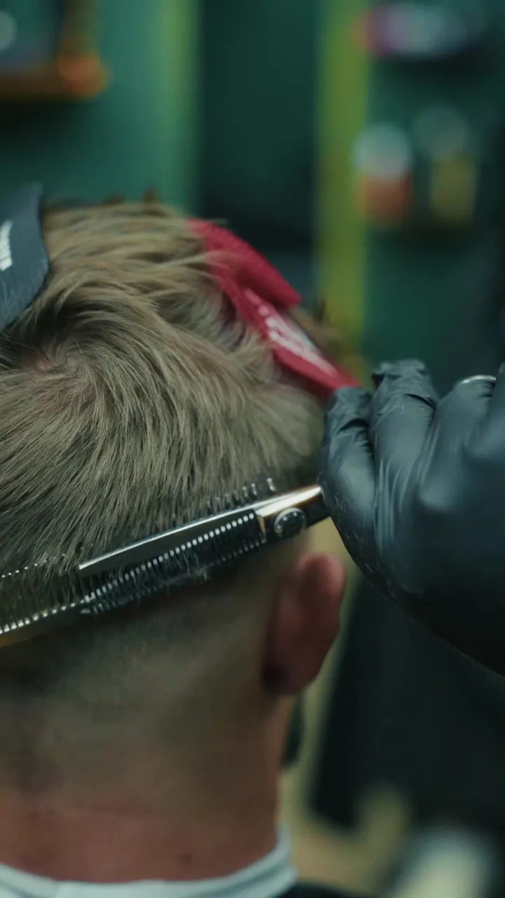 Men's haircut being finished at The Vintage Barbershop in Azizi Riviera, Meydan